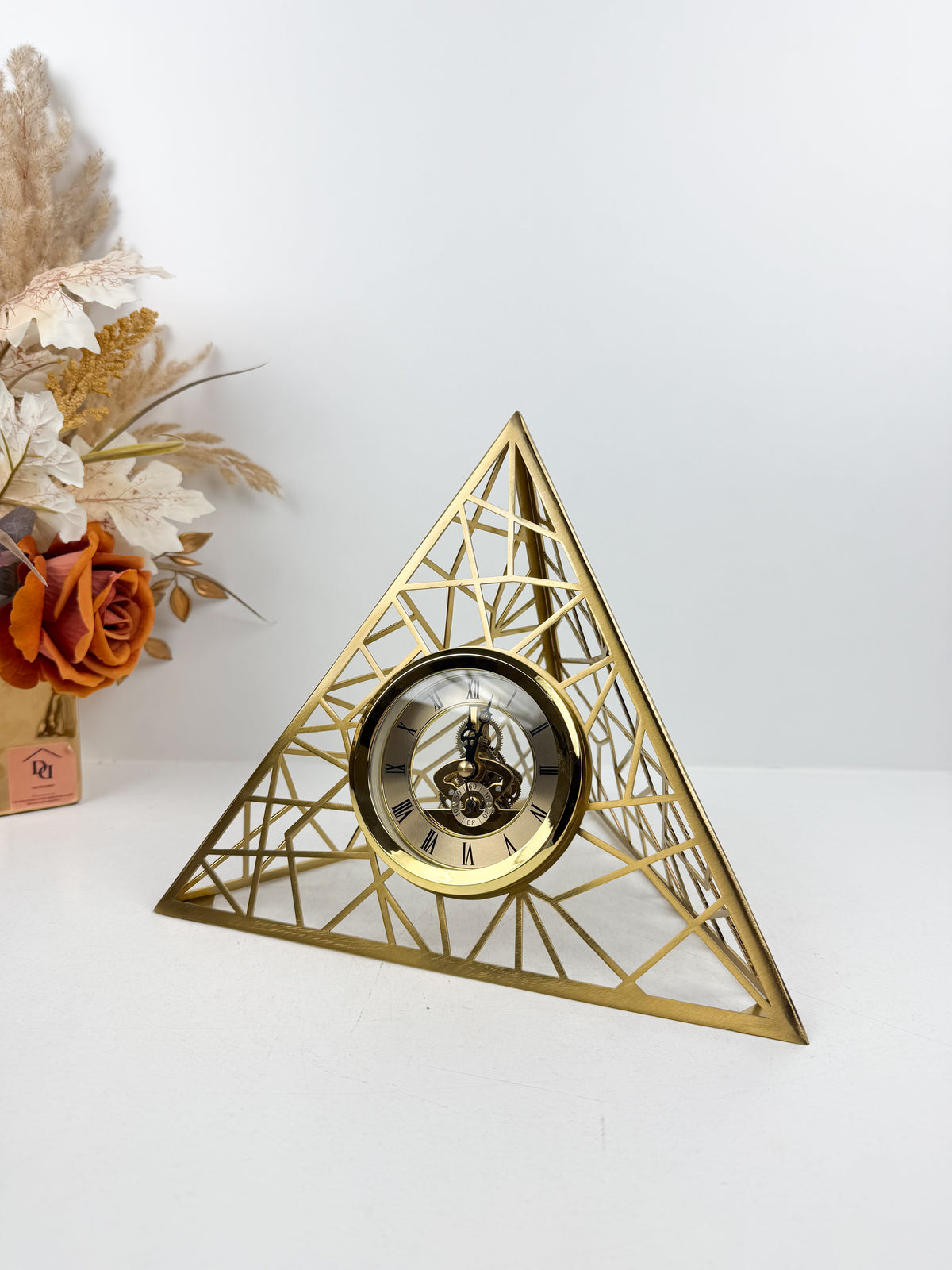 Horloge triangulaire au design géométrique épuré en métal doré