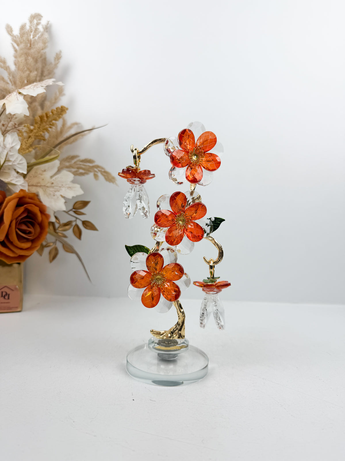 Fleur décorative en cristal en finition dorée et orange élégante.