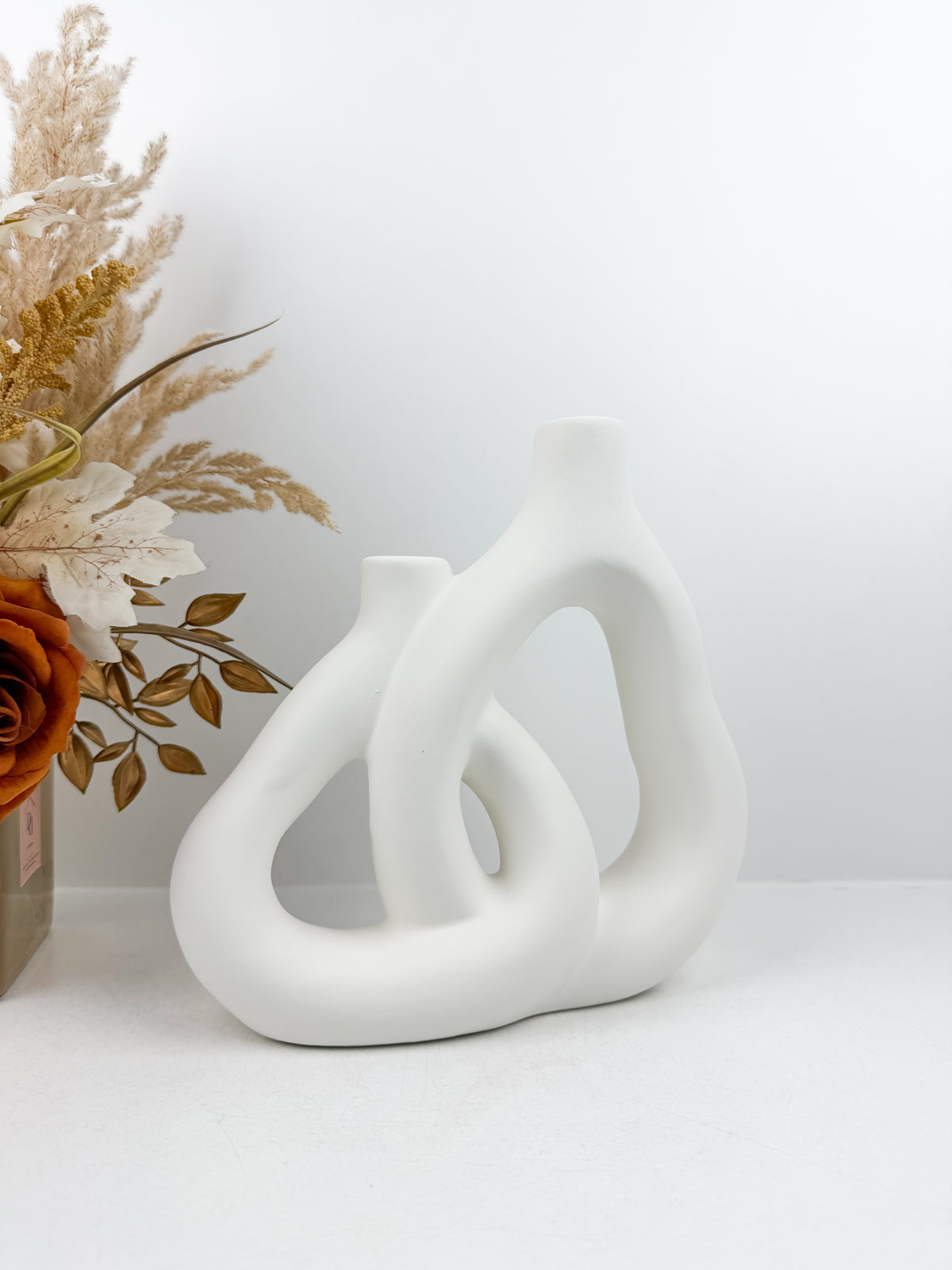 Vase blanc aux formes sculpturales et épurées pour un style moderne et raffiné.