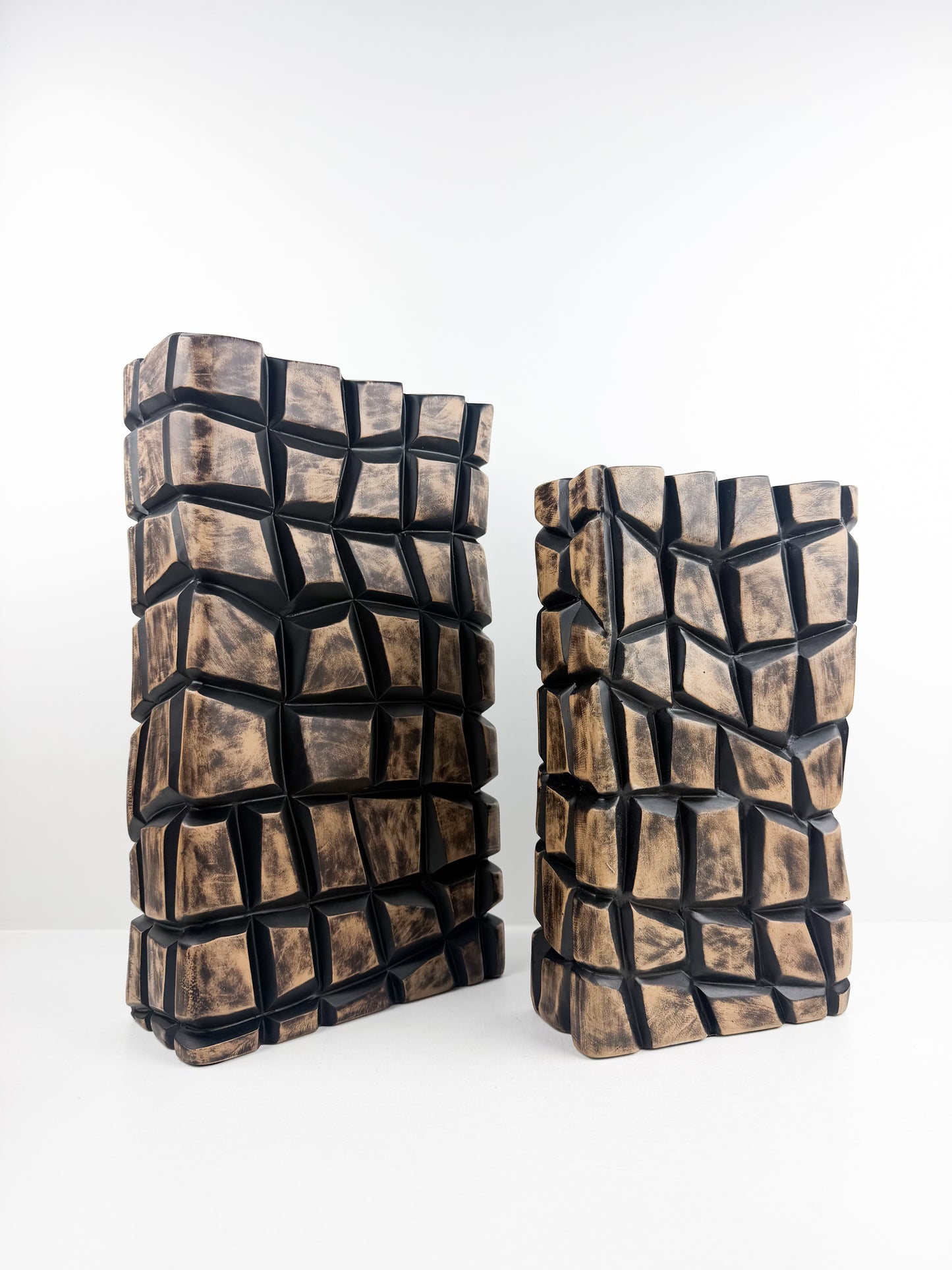 Duo de vases sculpturaux en résine mosaïque au design géométrique affirmé.