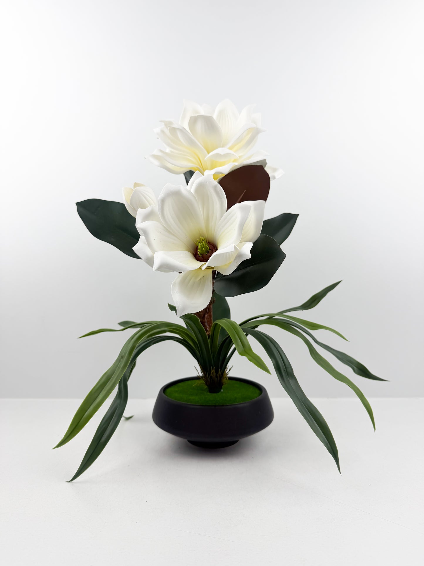 Fleurs artificielles blanches haut de gamme associées à un élégant pot noir