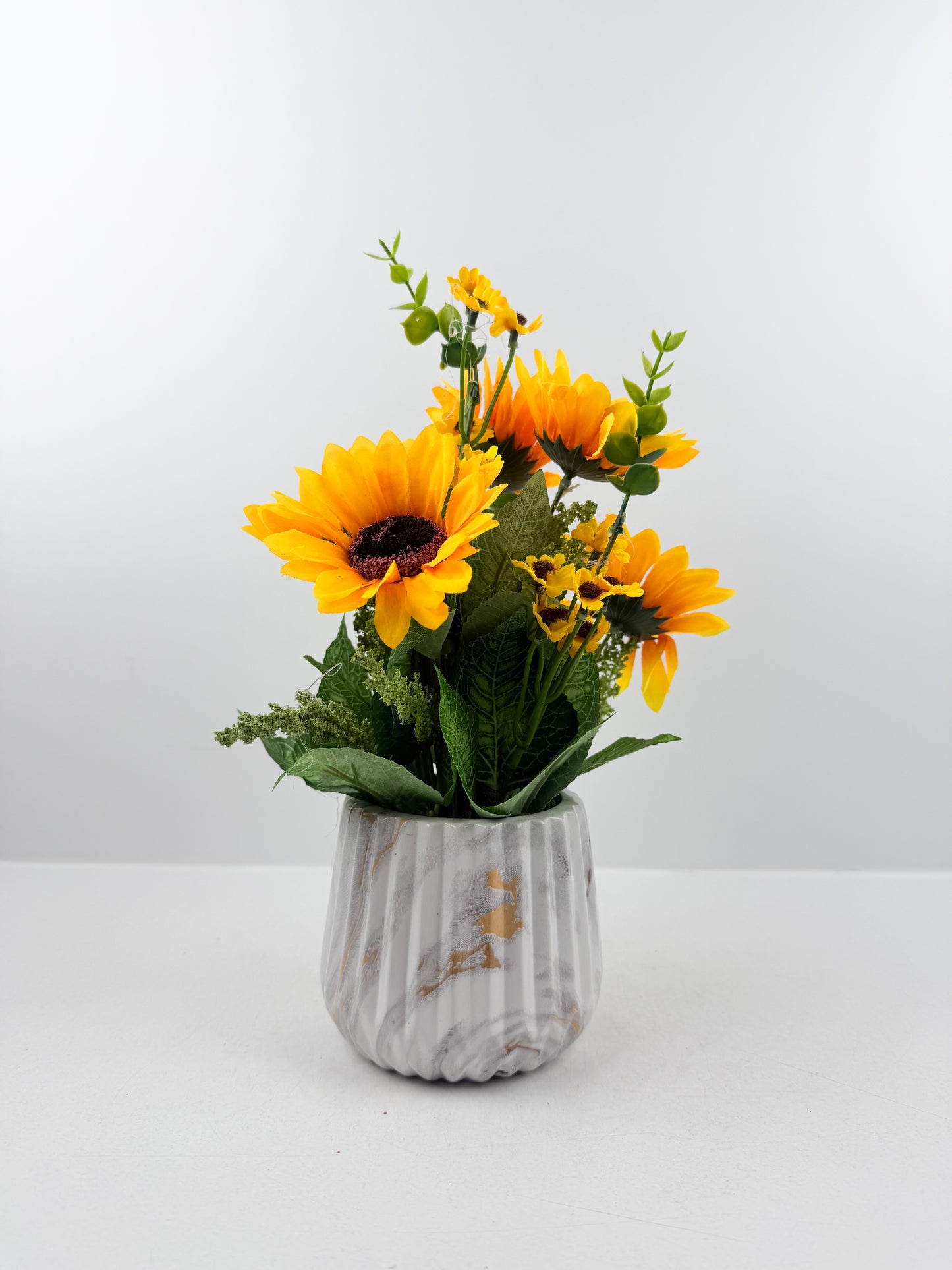 Tournesols artificiels d'une élégance intemporelle d'un pot blanc marbré haut de gamme