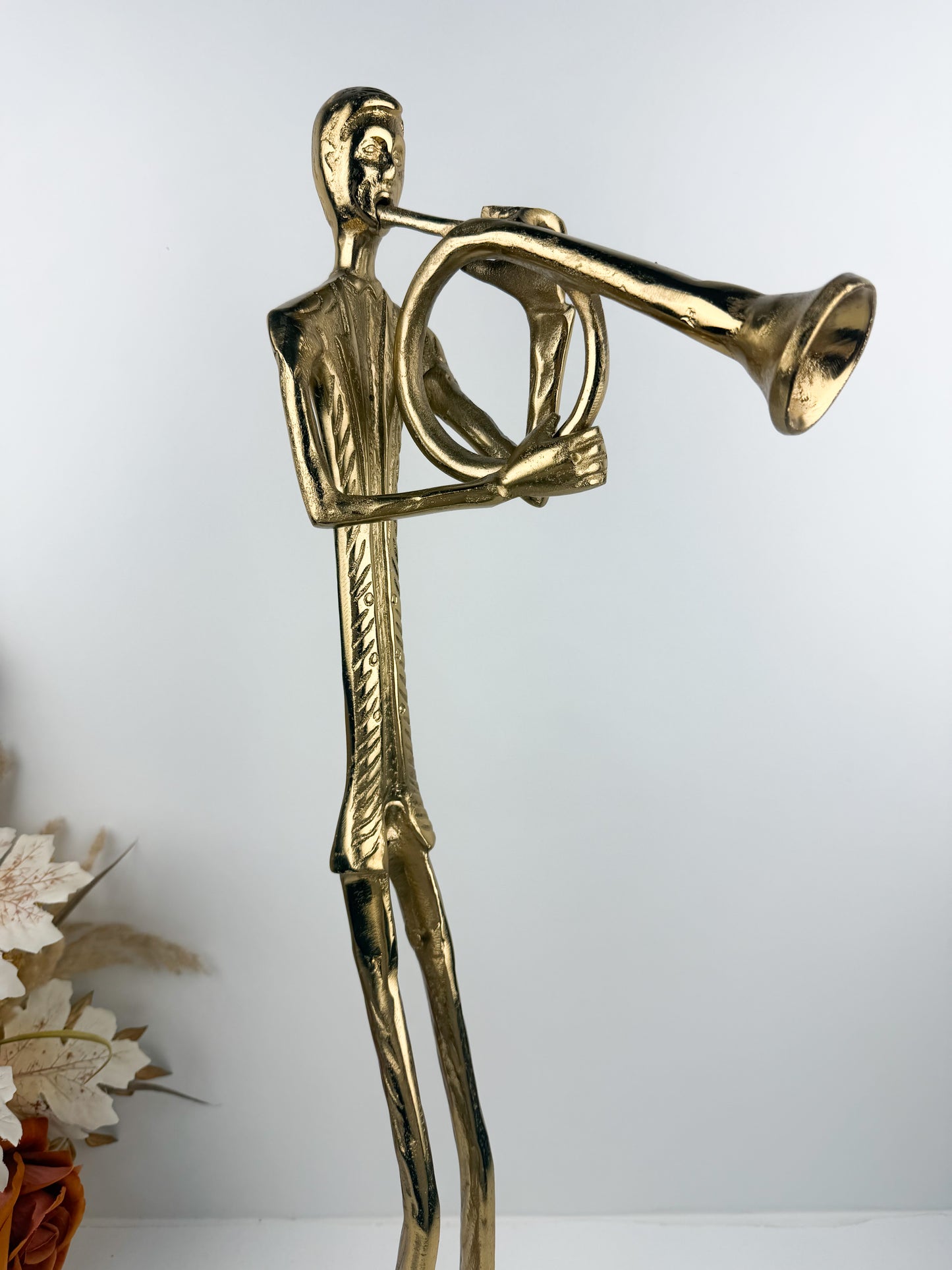 Figurine élégante d'un musicien jouant de la trompette en métal