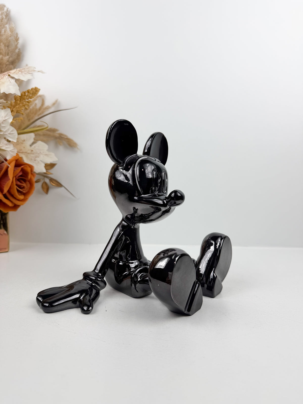 Statuette décorative en résine de Mickey Mouse en position assise.