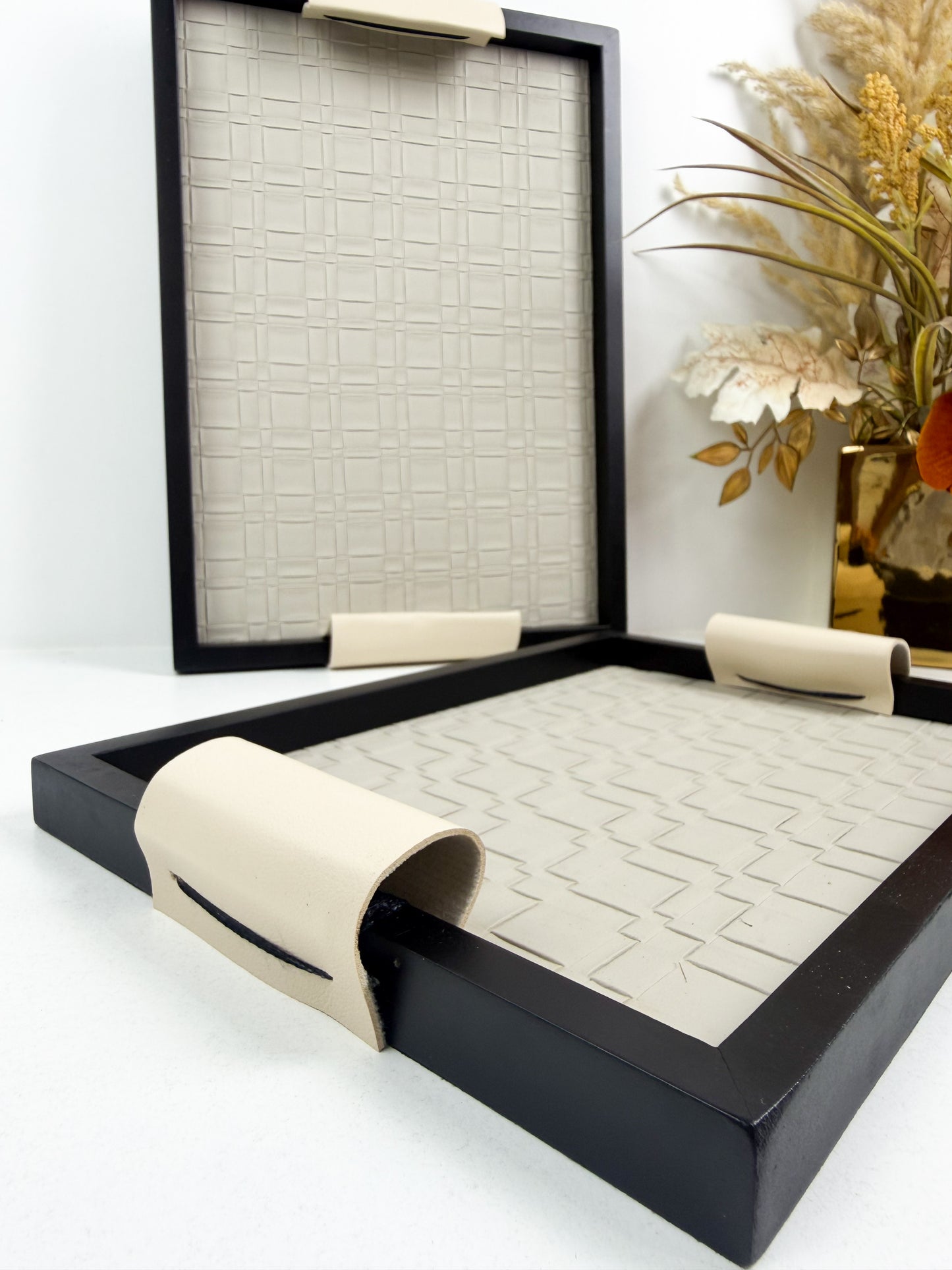 Ensemble de plateaux de service noirs avec une texture tressée et des poignées beiges