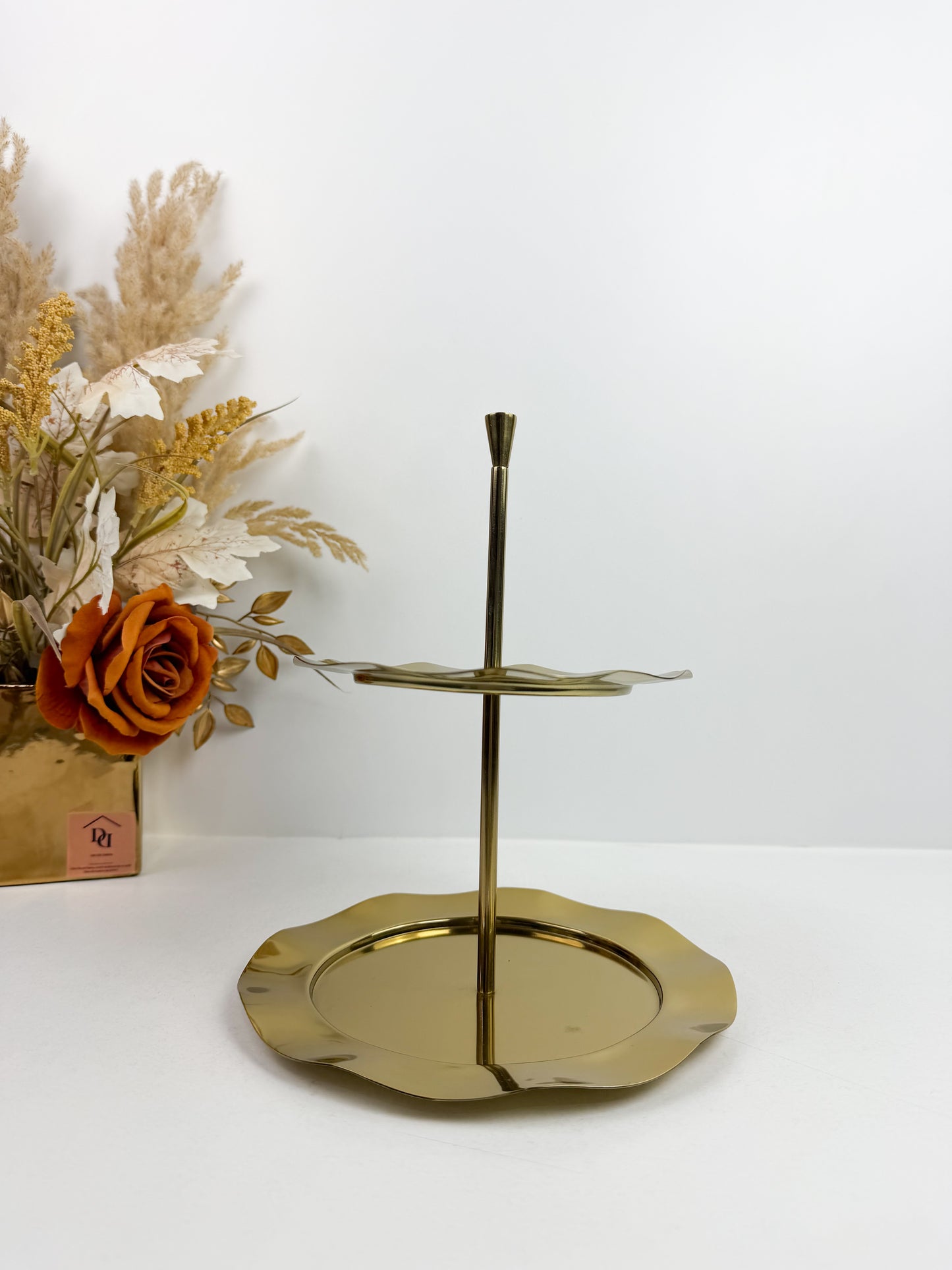 Plat de service ou présentoir à gâteaux 2 étages doré avec des bords festonnés.